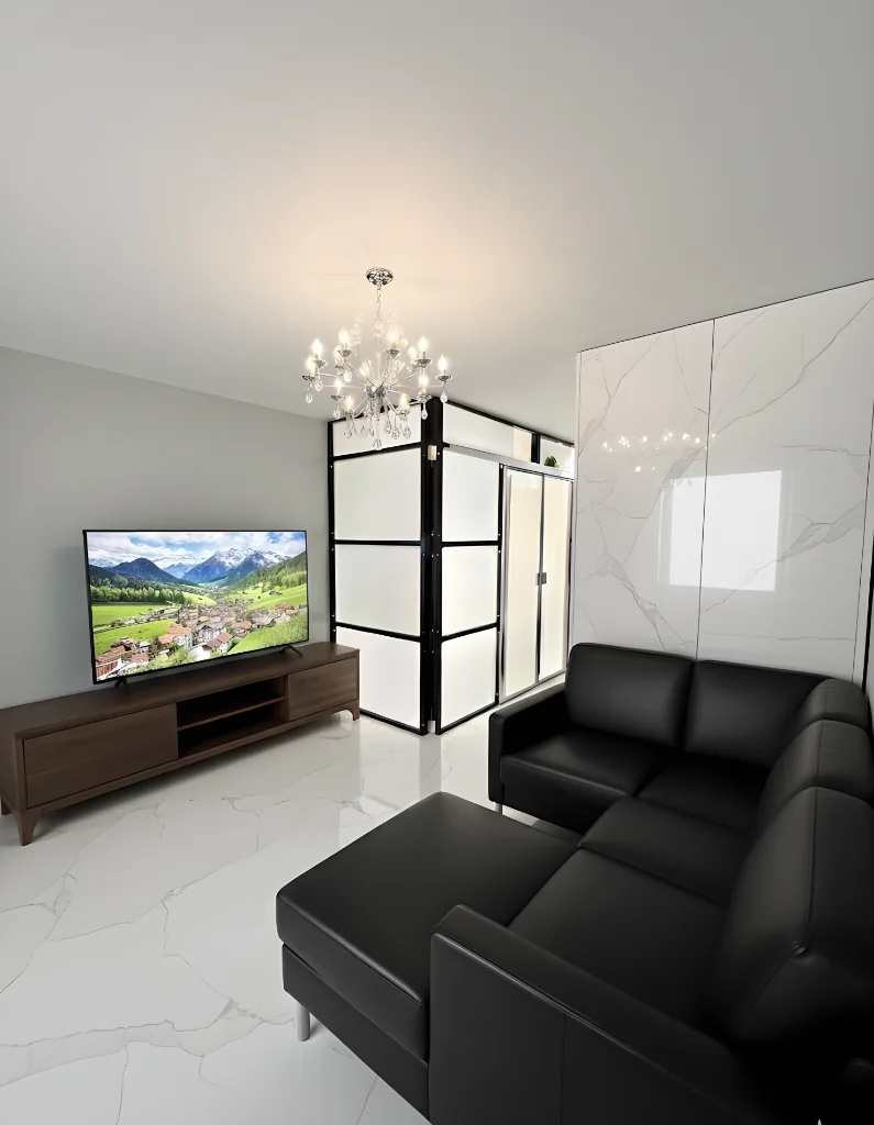Contemporary NYC apartment with 1W2R black-frame freestanding wall divider and crystal chandelier
