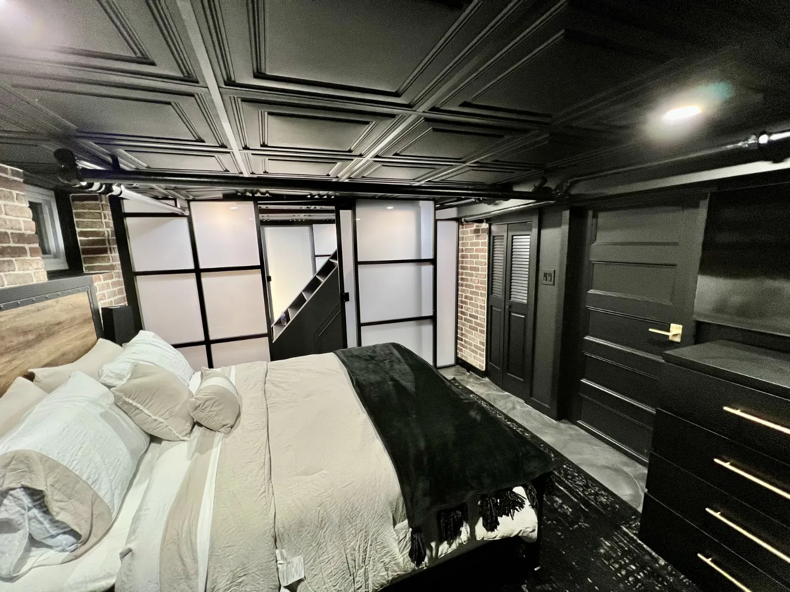 Basement divider with a door &mdash; freestanding frosted wall enclosing a private room downstairs