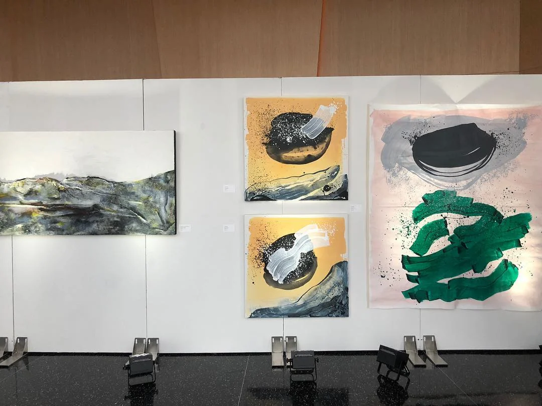 Freestanding gallery walls hung with artwork at an art show at the World Trade Center in New York City