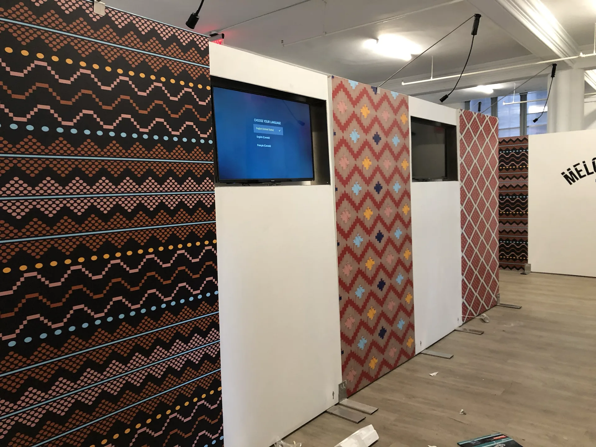 Freestanding event backdrop walls with printed graphics and inset TV screens
