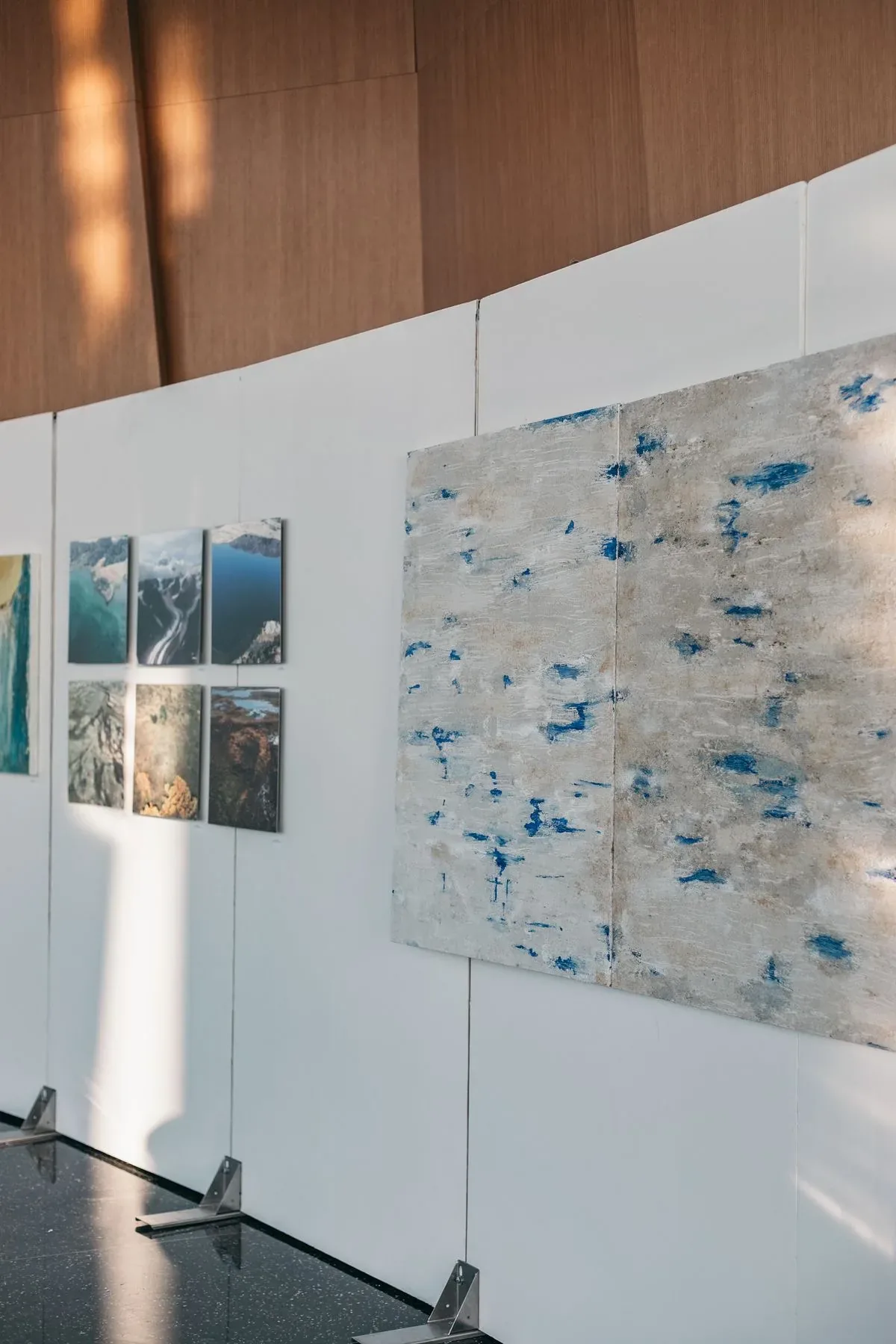 Freestanding gallery walls hung with artwork at a World Trade Center art event